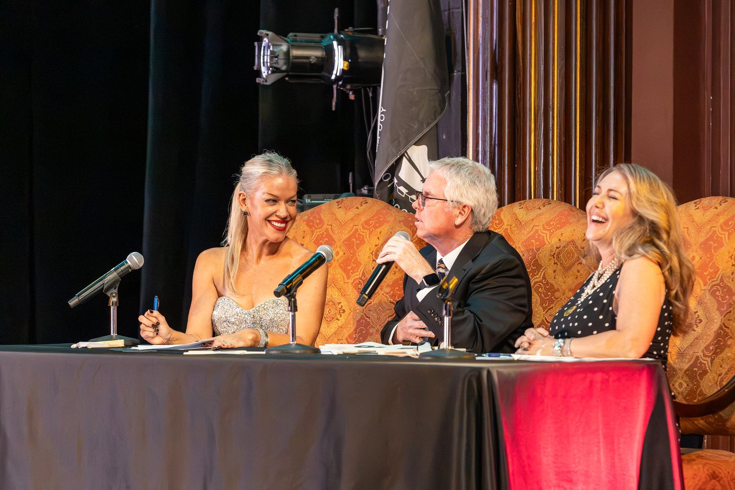 The 2026 judging panel at their table beside the Lewis Auditorium stage.
